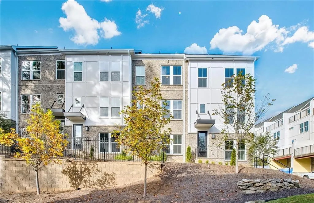 Photo is representation of exterior in community; not specific townhome building.