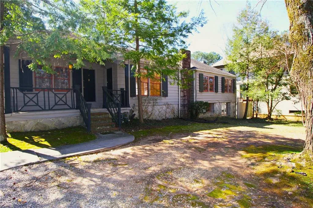 Front view showing the two entry doors on porch. Right door is to Unit 1 left door is to unit 3. Unit 2 is on the far right on the lower level
