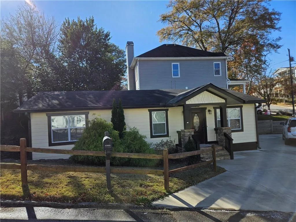 Traditional-style house with a chimney and a fenced front yard