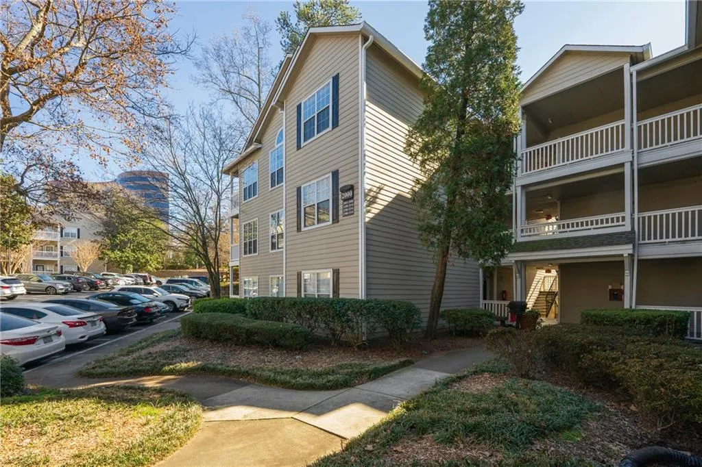 View of property exterior with uncovered parking