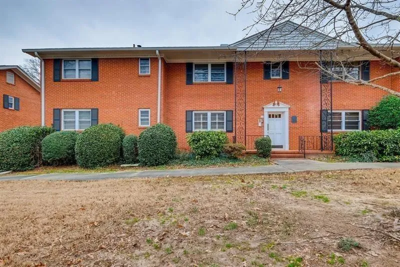Colonial-style house featuring brick siding