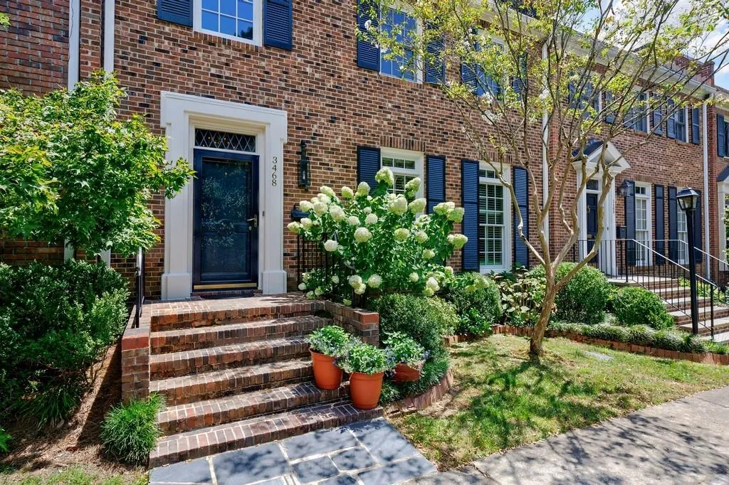 Traditional townhouse with a garden area in front.