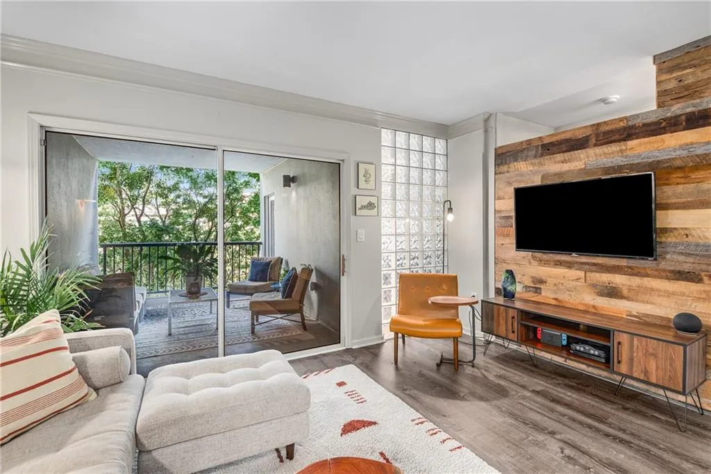 Living room with wood finished floors and crown molding