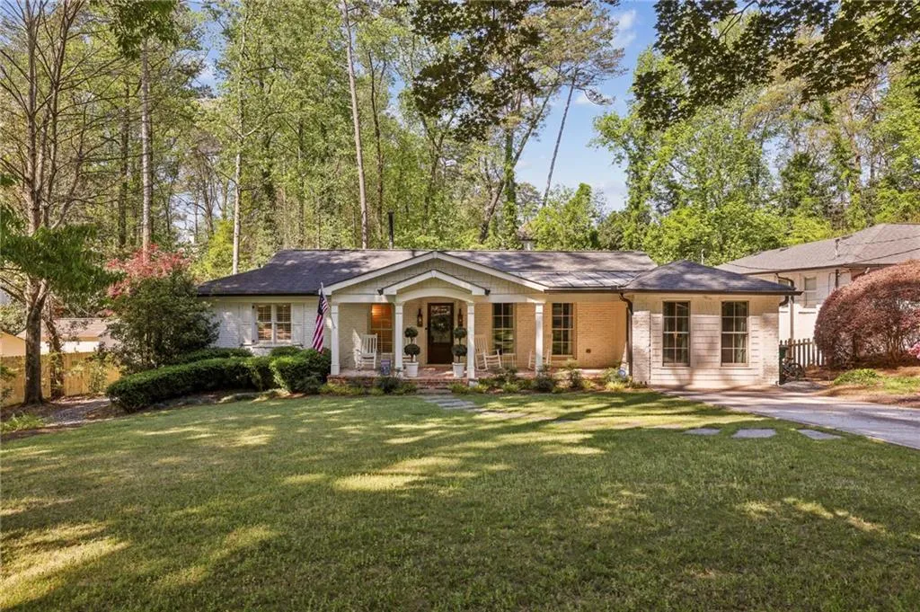 Ranch-style home featuring a porch and brick siding